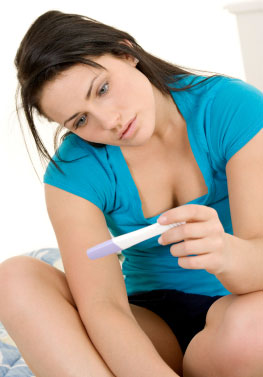 Young woman with a pregnancy test